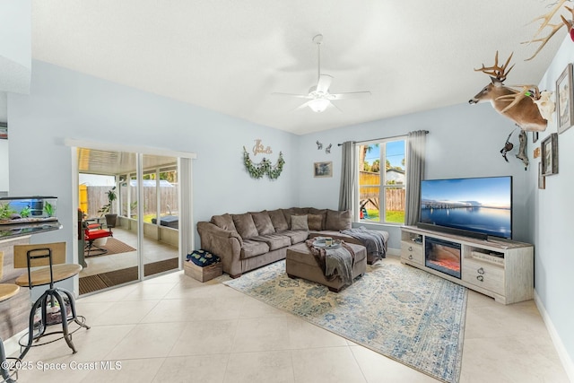 tiled living room with baseboards and ceiling fan