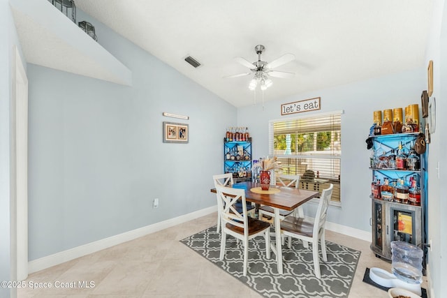 dining area featuring light tile patterned floors, baseboards, visible vents, lofted ceiling, and ceiling fan