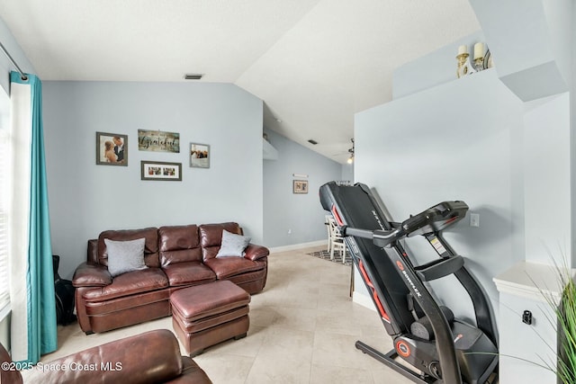 workout area with visible vents, a ceiling fan, baseboards, light tile patterned floors, and lofted ceiling