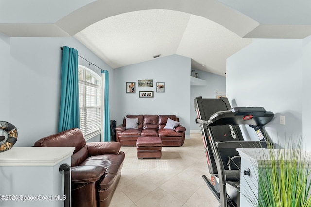 workout area featuring light tile patterned floors, visible vents, and lofted ceiling