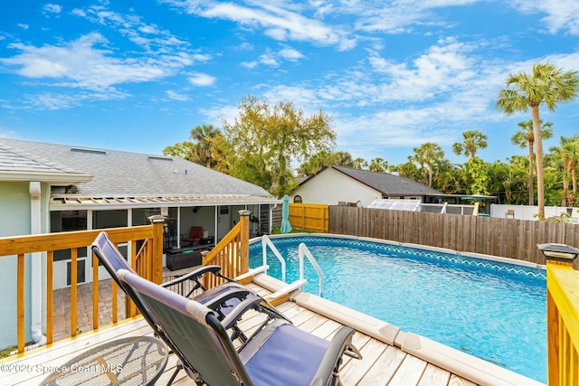 view of swimming pool with a fenced in pool, fence, and a wooden deck