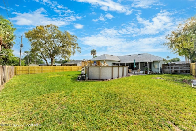 view of yard featuring a fenced in pool and a fenced backyard