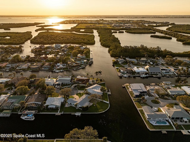 aerial view at dusk with a water view