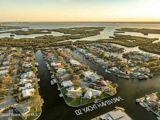 aerial view at dusk with a water view