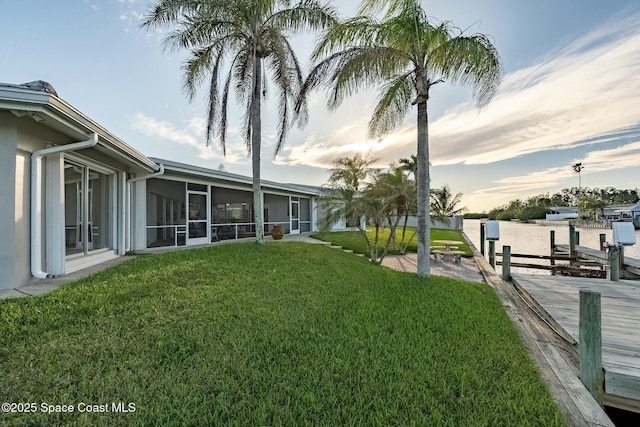 view of yard featuring a dock and a sunroom