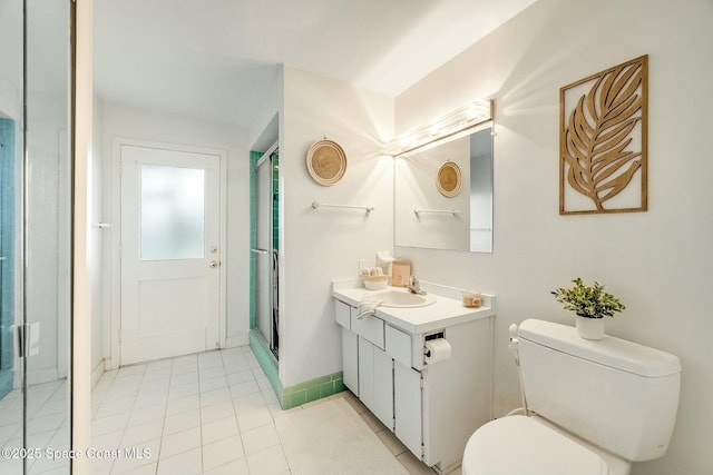 bathroom featuring vanity, baseboards, a shower stall, tile patterned floors, and toilet