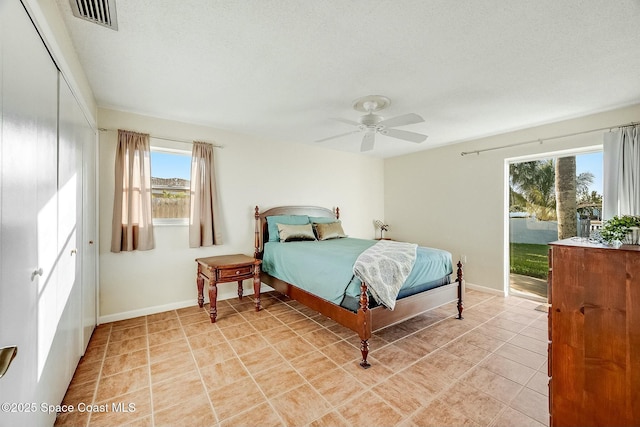 bedroom featuring a closet, visible vents, baseboards, and light tile patterned floors