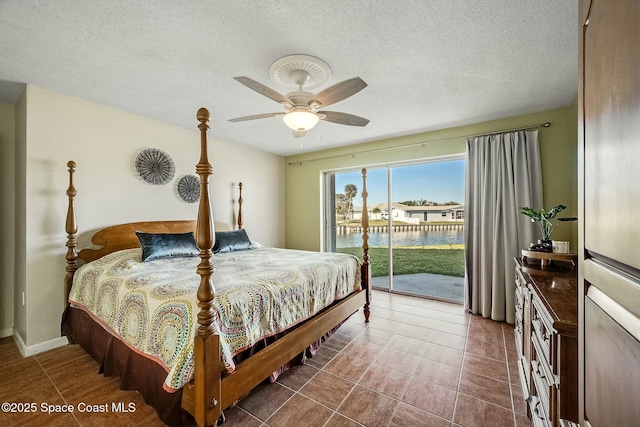 tiled bedroom with ceiling fan, a textured ceiling, and access to exterior