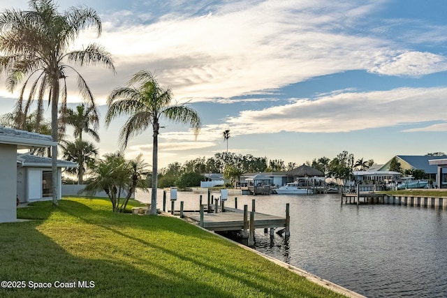 view of dock featuring a yard and a water view