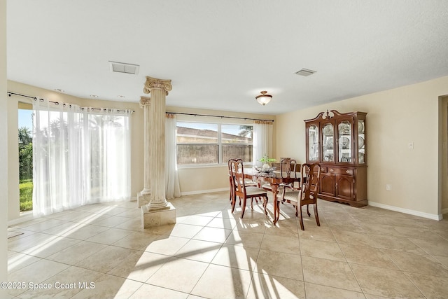 dining space with visible vents, light tile patterned flooring, and ornate columns