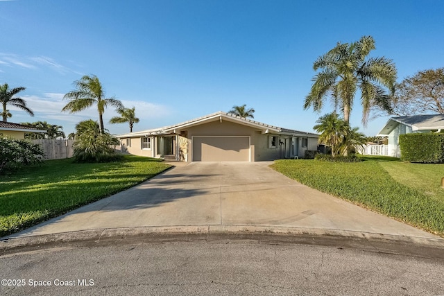 single story home featuring fence, concrete driveway, a front yard, stucco siding, and an attached garage