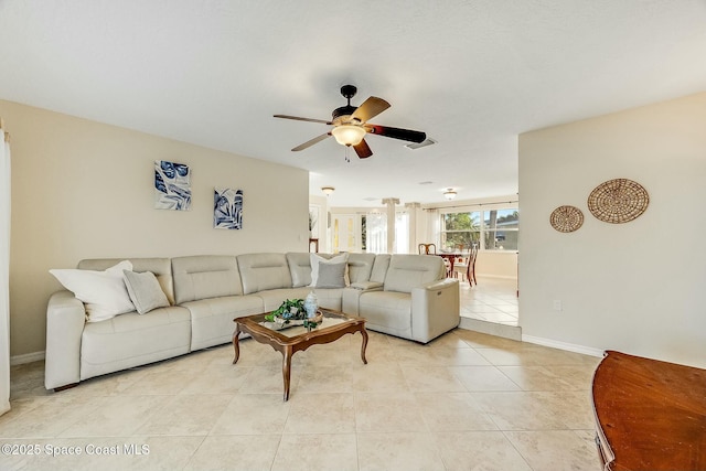 living room with light tile patterned floors, baseboards, visible vents, and ceiling fan