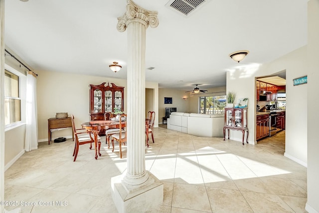 interior space featuring visible vents, a ceiling fan, light tile patterned floors, baseboards, and ornate columns