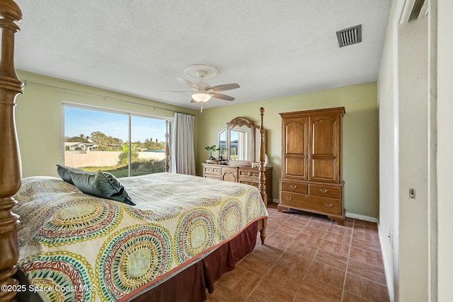 bedroom with visible vents, dark tile patterned flooring, access to outside, baseboards, and ceiling fan