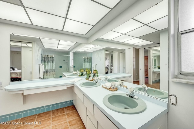 full bathroom featuring a sink, connected bathroom, a shower with curtain, and tile patterned floors