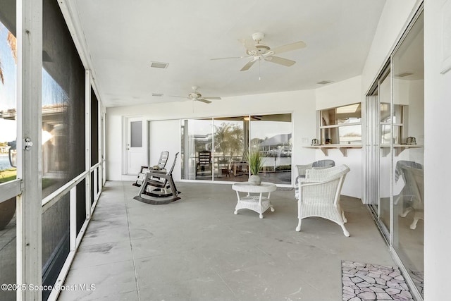 sunroom / solarium with visible vents and ceiling fan