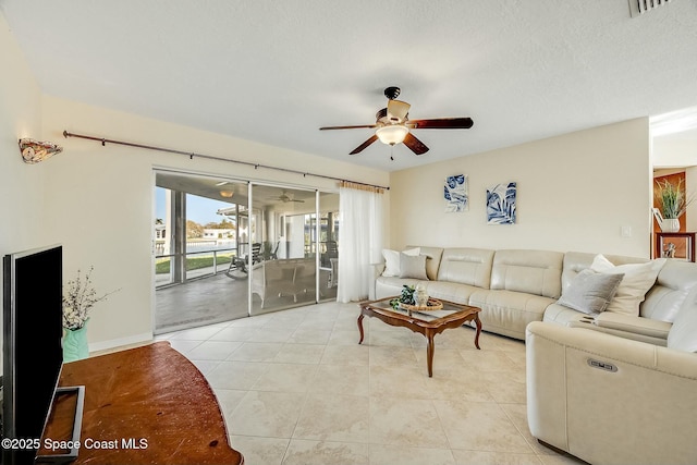 living area with light tile patterned floors, visible vents, and a ceiling fan