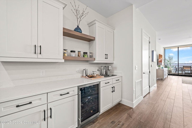 kitchen featuring visible vents, dark wood-type flooring, wine cooler, floor to ceiling windows, and open shelves