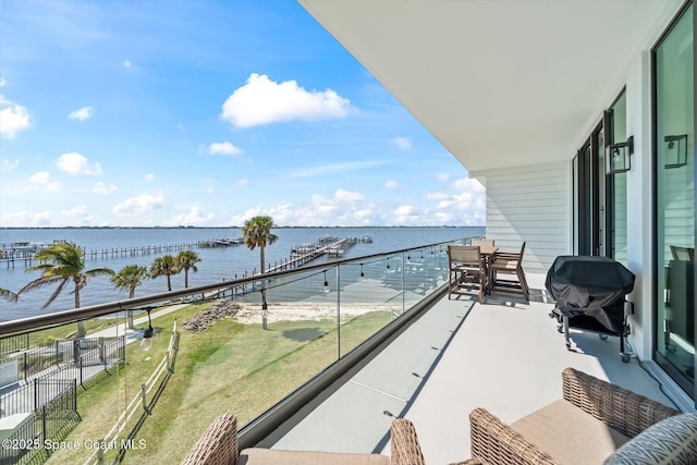 balcony featuring a water view and area for grilling