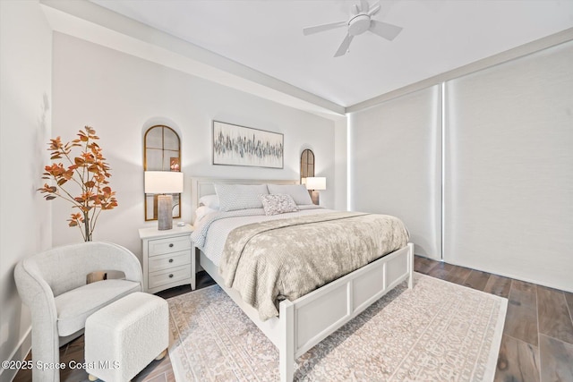 bedroom featuring ceiling fan and dark wood-style flooring