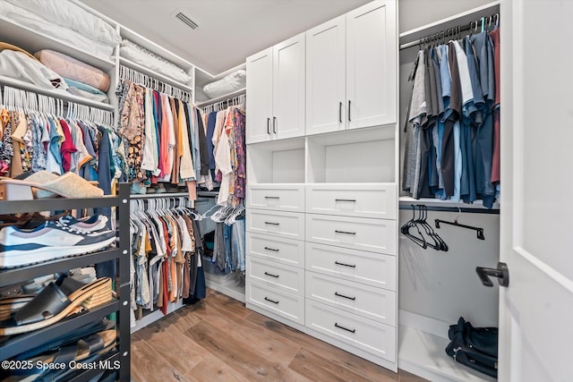 spacious closet with light wood-type flooring and visible vents