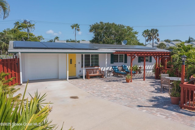 324 Harbor Dr, Cape Canaveral, FL 32920 - ranch-style house featuring a garage, driveway, and roof mounted solar panels