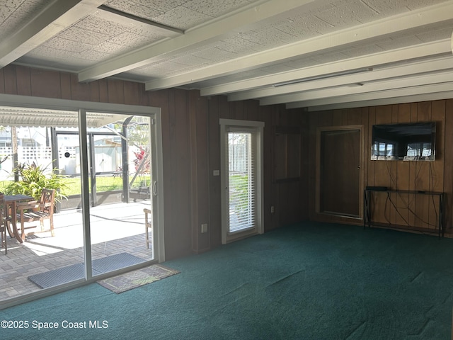 324 Harbor Dr, Cape Canaveral, FL 32920 - doorway with beam ceiling, carpet, and wood walls