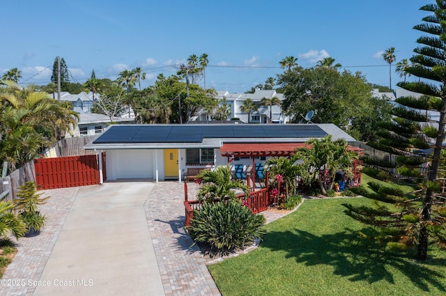 324 Harbor Dr, Cape Canaveral, FL 32920 - view of front facade with roof mounted solar panels, concrete driveway, and a garage