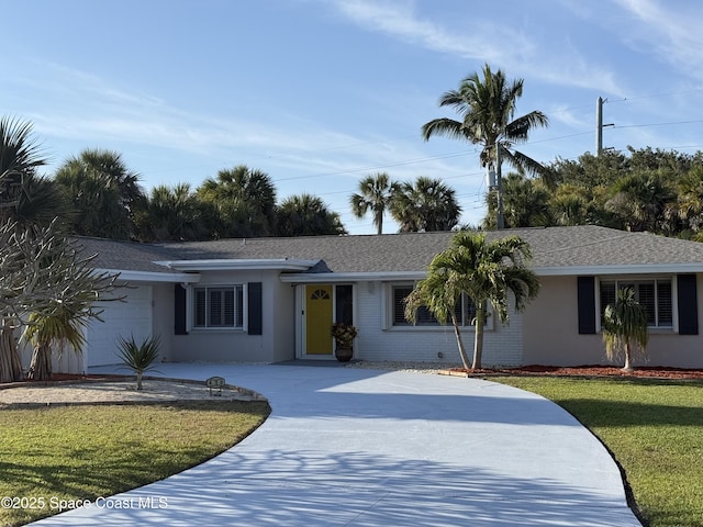 ranch-style house with a shingled roof, stucco siding, concrete driveway, a front lawn, and a garage