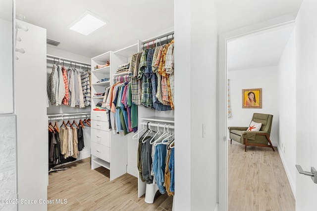 spacious closet with visible vents and wood finished floors