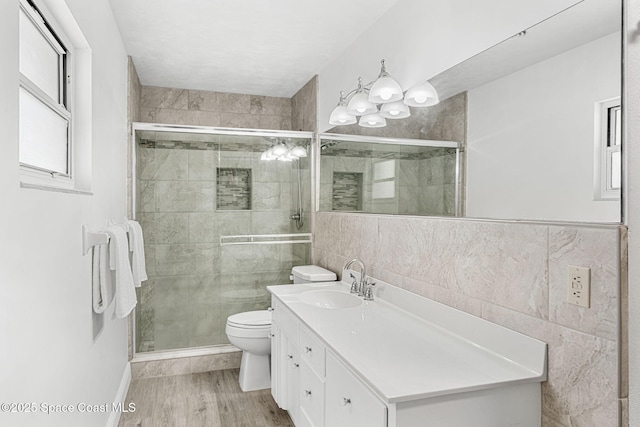 bathroom featuring vanity, tile walls, and a stall shower