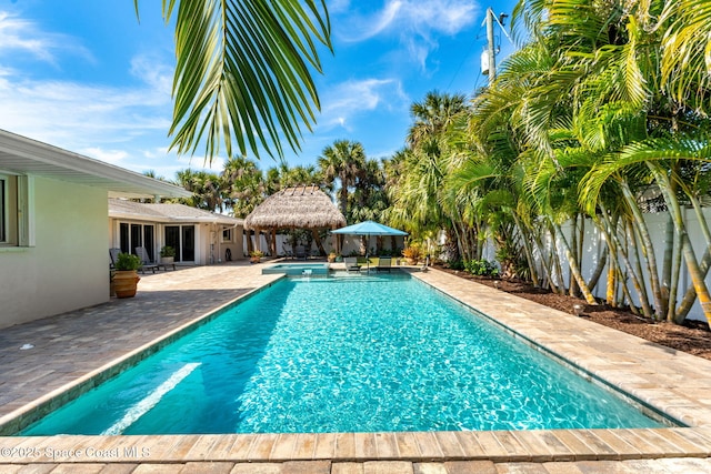 pool featuring a patio and fence