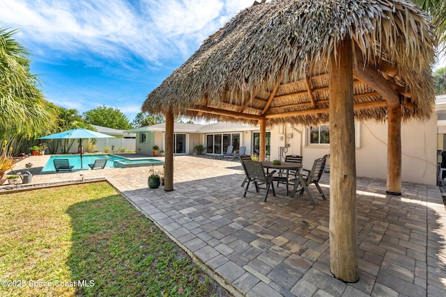 view of patio / terrace featuring a gazebo, fence, and an outdoor pool
