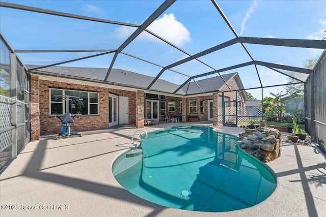 pool with glass enclosure and a patio