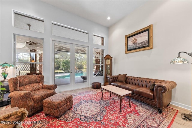 living area featuring recessed lighting, french doors, baseboards, and wood finished floors