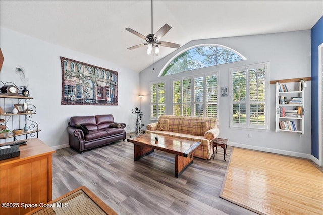 living room featuring wood finished floors, a healthy amount of sunlight, ceiling fan, and vaulted ceiling