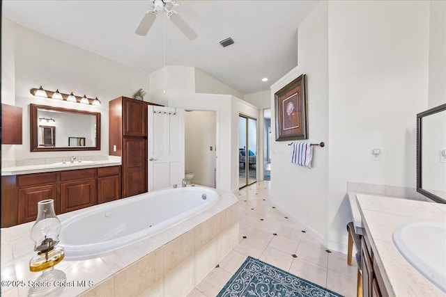 full bathroom featuring a sink, visible vents, toilet, and two vanities