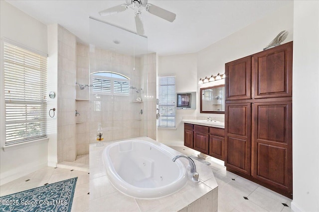 bathroom with a ceiling fan, a whirlpool tub, tile patterned flooring, walk in shower, and vanity