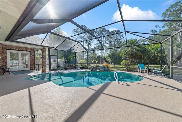 outdoor pool featuring a patio, french doors, and a lanai