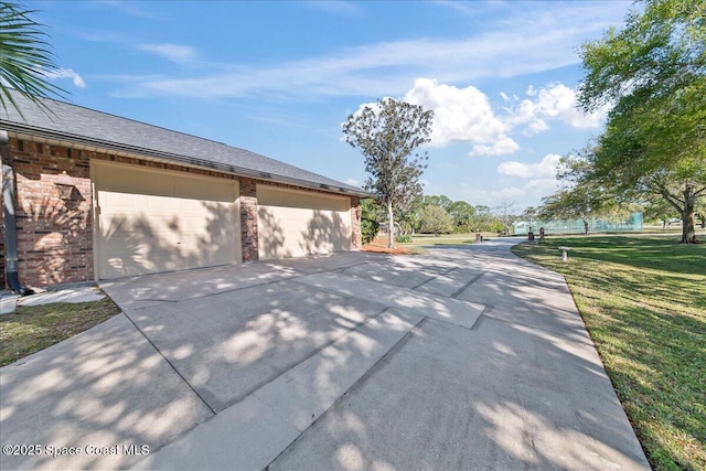 view of property exterior with a lawn and a garage