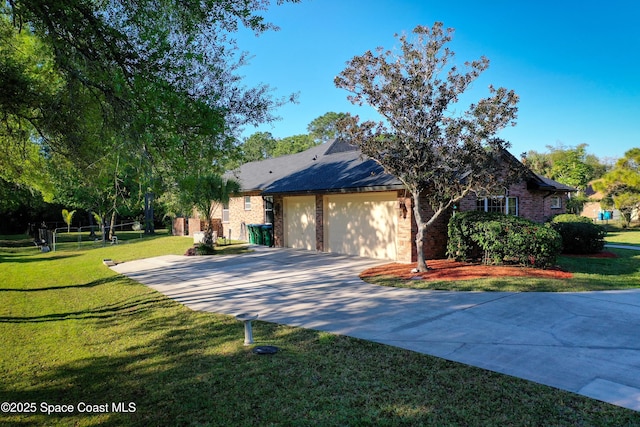 view of front of home with brick siding, an attached garage, driveway, and a front yard