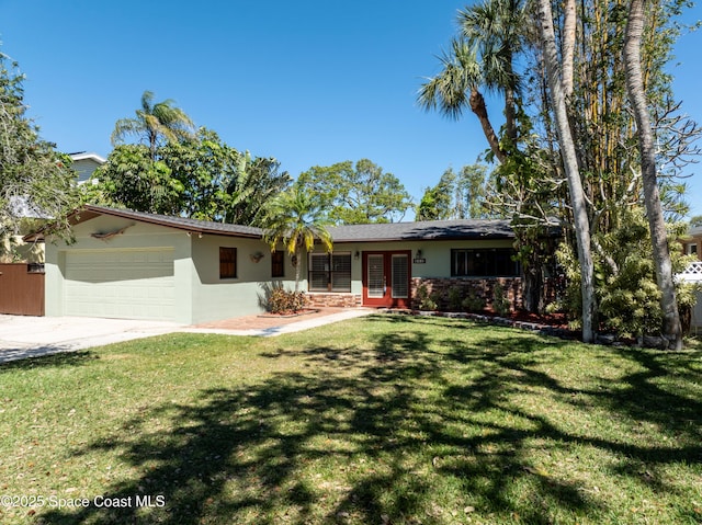 ranch-style home featuring stucco siding, driveway, french doors, a front yard, and an attached garage