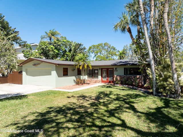 ranch-style house with a front lawn, stucco siding, french doors, a garage, and driveway