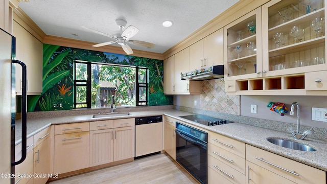 kitchen featuring a sink, black appliances, light brown cabinetry, and under cabinet range hood