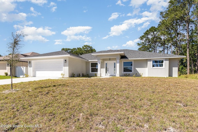 531 Ortega St SE, Palm Bay, FL 32909 - view of front of home featuring a garage, concrete driveway, a front lawn, and stucco siding