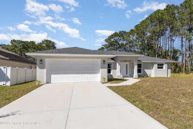 531 Ortega St SE, Palm Bay, FL 32909 - view of front facade with fence, a front yard, stucco siding, a garage, and driveway