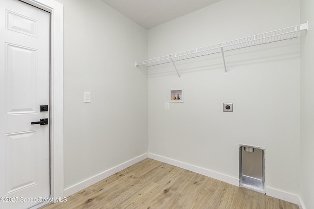 531 Ortega St SE, Palm Bay, FL 32909 - laundry area featuring electric dryer hookup, light wood-type flooring, baseboards, hookup for a washing machine, and laundry area