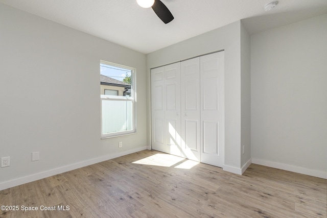 531 Ortega St SE, Palm Bay, FL 32909 - unfurnished bedroom with wood finished floors, baseboards, a closet, and ceiling fan