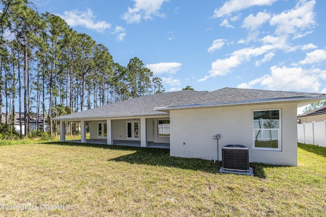 531 Ortega St SE, Palm Bay, FL 32909 - back of property featuring a yard, central AC unit, fence, and stucco siding