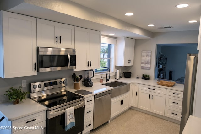 kitchen with visible vents, light countertops, recessed lighting, stainless steel appliances, and a sink